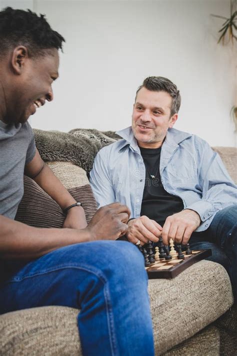 A Gay Couple Enjoying Time Indoors At Home Playing Chess Stock Photo Image Of Black Lgbtq