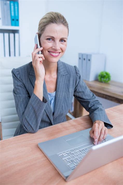 Pretty Blonde Businesswoman Phoning And Using Her Laptop Stock Image Image Of Phoning Classy