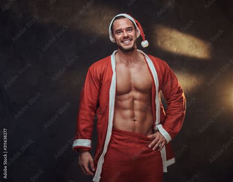 Happy Smiling Man With Naked Torso Is Posing For Photographer At Photo Studio Stock Photo