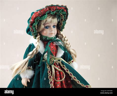 Vintage Porcelain Doll Girl Blonde With Braids With Blue Eyes In A Green Dress With Red Trim And
