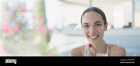 Portrait Smiling Confident Brunette Woman Eating Raspberry Stock Photo Alamy