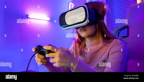 Gamer in VR headset glasses exploring metaverse play video game online ...