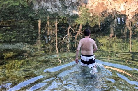 Premium Photo Rear View Of Shirtless Mature Man Standing In Lake At Forest