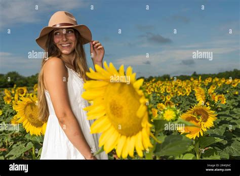 A Lovely Blonde Model Poses Outdoor While Enjoying The Summer Weather In A Field Of Wild