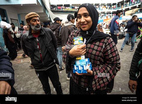 Displaced Palestinians Receive Food Aid At The United Nations Relief