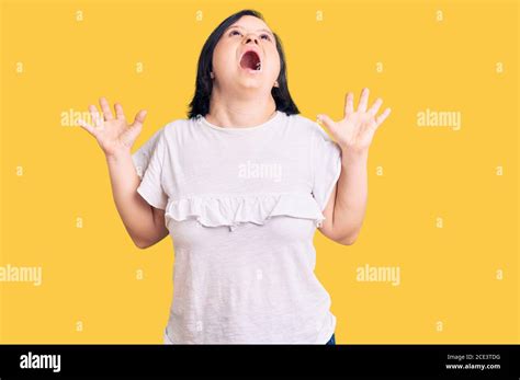 Brunette Frau mit Down Syndrom tragen lässige weiße T Shirt feiern Verrückt und verrückt nach