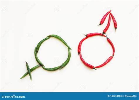 Male And Female Gender Signs Made Of Red And Green Hot Peppers On A Light Background Stock