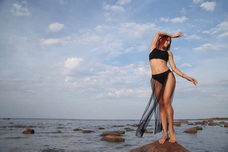 young slender woman in a bikini on the background of the seaの素材 FY310199273748 ストックフォトの