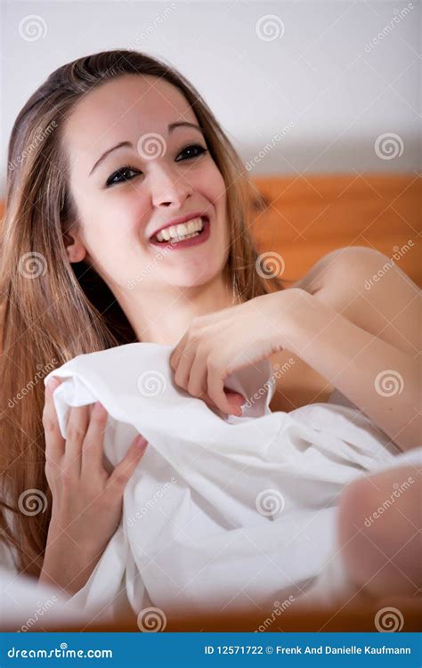 Beautiful Brunette Sitting On The Bed Stock Photo Image Of Long Happy 12571722