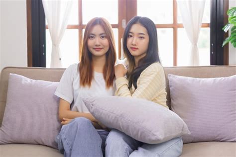 Premium Photo Relax At Home Concept Lgbt Lesbian Couple Sitting On Couch And Looking At Camera