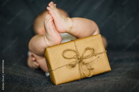 Naked Newborn Baby Legs Feet With Eco Friendly Natural Paper Gift Boxes Lying On Grey
