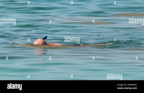 Unrecognizable Man Swimming With Snorkeling Breathing Mask Under Sea