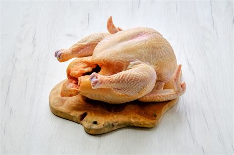 Premium Photo Fresh Raw Whole Chicken On Wooden Cutting Board