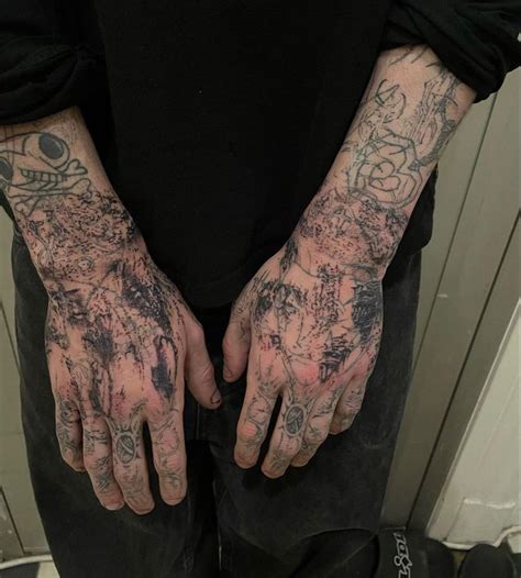 A Man With Tattoos On His Arms And Hands