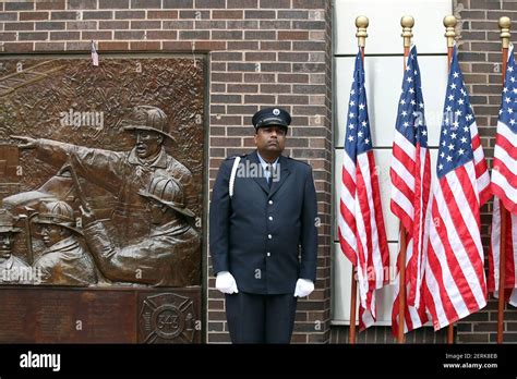 An Fdny Firefighter Stands Guard Alongside The Fdny 343 Memorial Wall