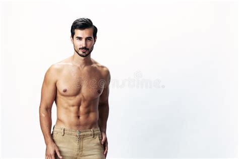 Man Athlete Model With A Naked Torso And Six Pack Abs Sporty Inflated Figure And Tan On A White