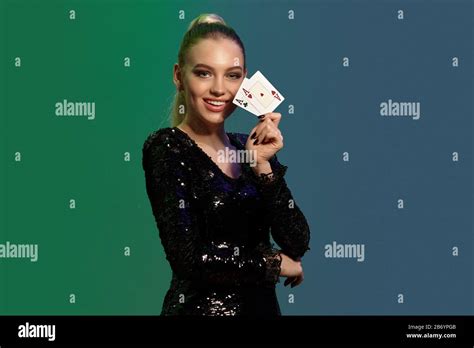 Charming Blonde Woman With Ponytail In Jewelry And Black Sequin Dress She Smiling Showing Two