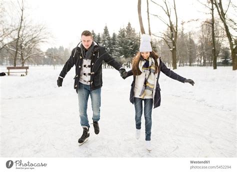 Couple ice skating on a frozen lake - a Royalty Free Stock Photo from Photocase