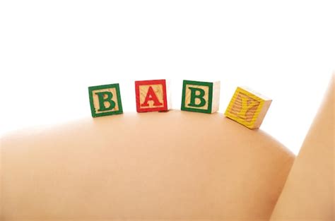 Premium Photo Midsection Of Naked Pregnant Woman With Text On Belly Against White Background