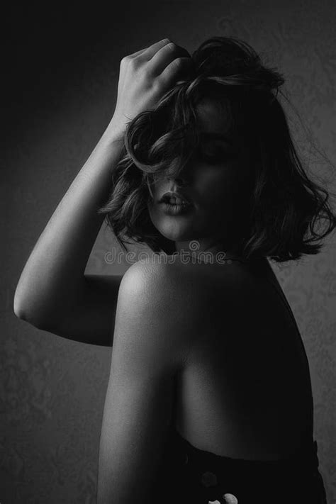 Black And White Portrait Of Seductive Brunette Model With Naked Shoulders Posing With Dramatic