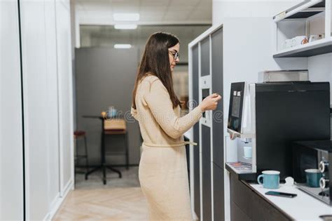 Stunning Brunette Woman Preparing Her A Coffee During Break At Work Woman Preparing Coffee