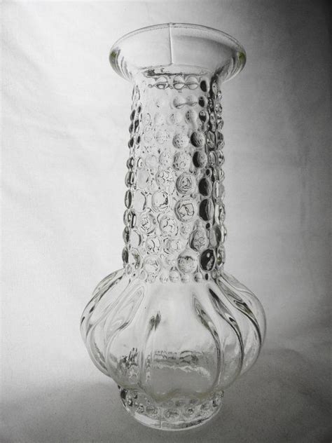 A Clear Glass Vase Sitting On Top Of A White Table