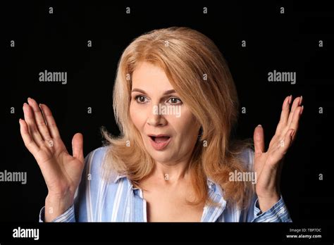 Surprised Mature Woman On Dark Background Stock Photo Alamy
