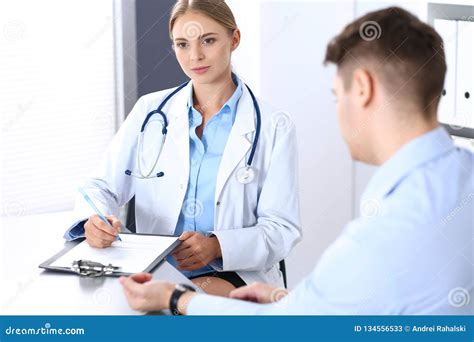 Doctor And Patient In Hospital Beautiful Blonde Physician Consulting Business Man About His