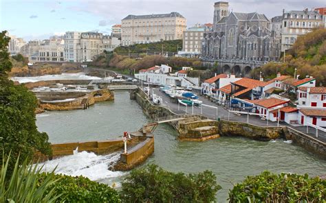 1920x1080 Resolution White And Brown Houses Beside Body Of Water Near Concrete Buildings At