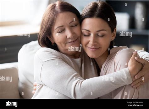Mature Mother And Adult Daughter Hugging Enjoying Tender Moment Stock Photo Alamy