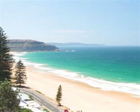 A Beach With Cars Parked On The Side Of It