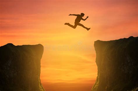 Man Jumping Over The Cliff Silhouette Stock Photo Image Of Nature