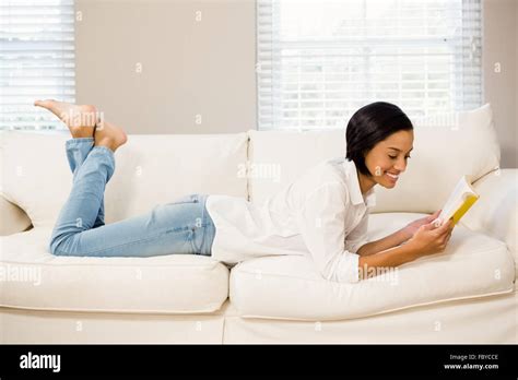 Smiling Brunette Reading A Book Stock Photo Alamy