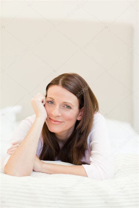 Pretty Woman Lying Down On Her Bed Stock Photo Wavebreakmedia 10849102