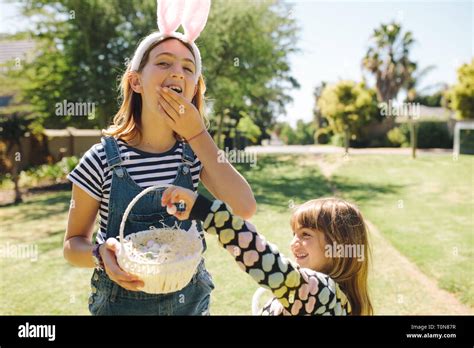 Kids Eating Sweets From A Basket Standing In A Garden Kids Having Fun