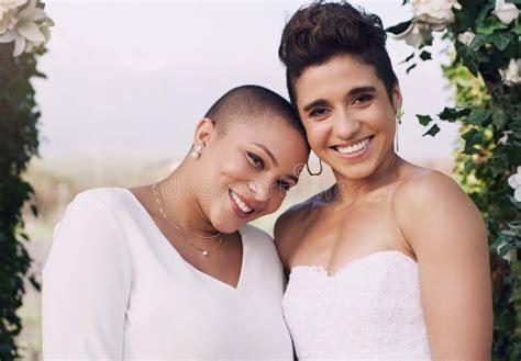 Wedding Happiness And Portrait Of Lesbian Couple With Smile Love And Diversity In Flower Arch