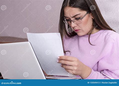Student Study Sitting On The Couch And Studying The Material On The