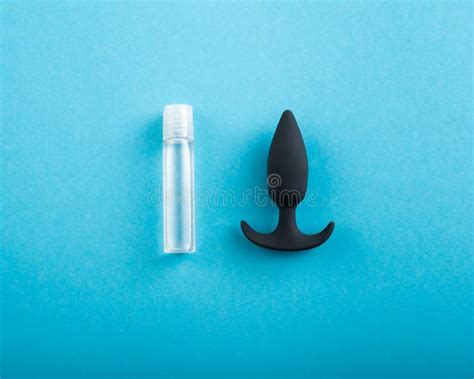 Top View Of Black Anal Plug And Tube Of Lubricant On A Blue Background Stock Image Image Of