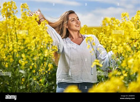 Portrait Of A Beautiful Blonde Hispanic Woman In A Blooming Canola Field Stock Photo Alamy