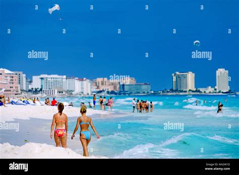Two Bikini Clad Women Walking On The Cancun Beach On Mexico S Stock