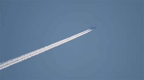 Airplane flying at high altitude with contrail 15941276 Stock Video at