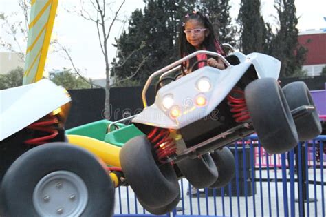 Year Old Brunette Girl With Glasses Has Fun On An Amusement Park Ride