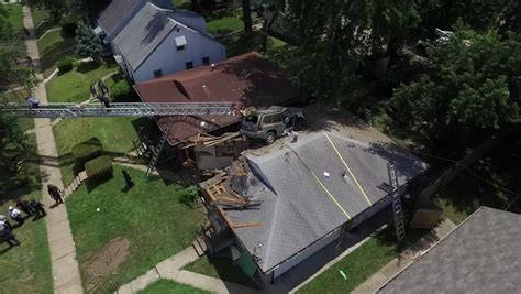 Remarkable Photo Shows An Suvs Crash Landing — On The Roof Of A House