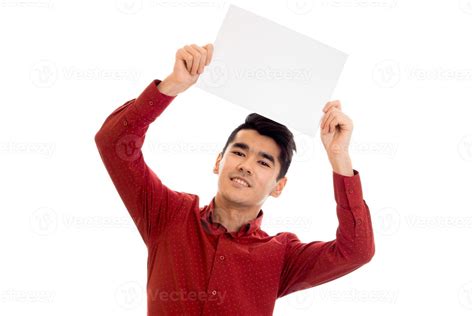 Youn Happy Brunette Male Model In Red Shirt Posing With Empty Placard In His Hands And Looking
