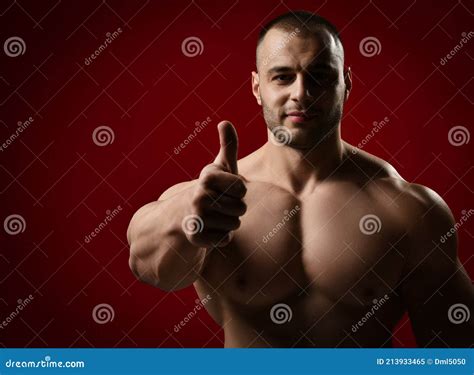 Portrait Of Healthy Strong Muscular Unshaved Man Bodybuilder Standing With Naked Chest And