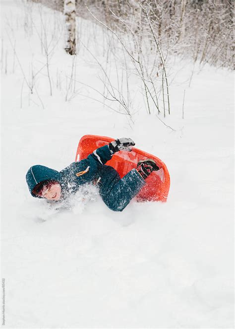 boy falling  sled  snow  stocksy contributor stephen morris