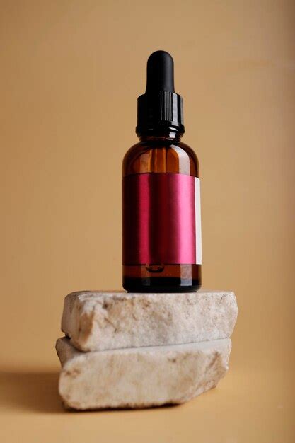 Premium Photo Bottle Of Serum With Pipette On Pedestal And Nude Background