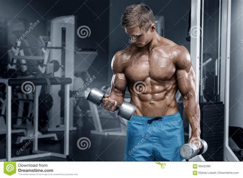 Muscular Man Working Out In Gym Doing Exercises With Dumbbells Bodybuilder Male Naked Torso Abs