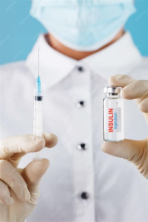 The doctor holds a syringe for injections and an ampoule with insulin