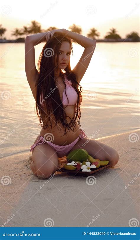 Carefree Woman Enjoying Beautiful Sunset On Tropical Beach Bikini